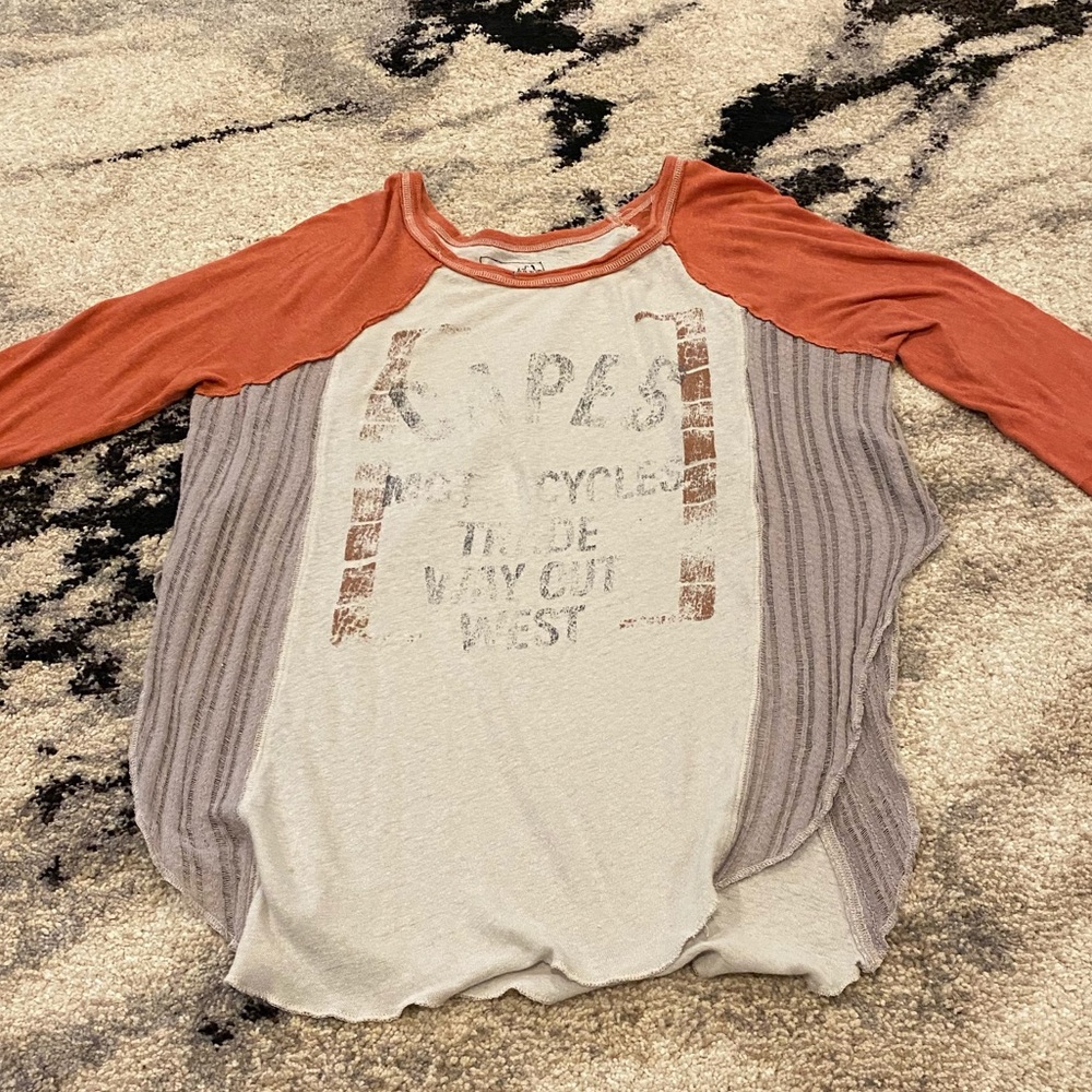 We the free loose fitting baseball tee with slits up the side for an open look.